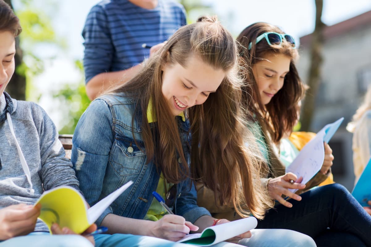 Students on campus with notebooks
